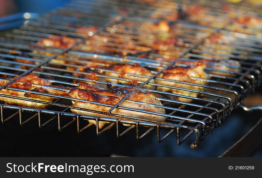 Grilled chicken in barbecue grate