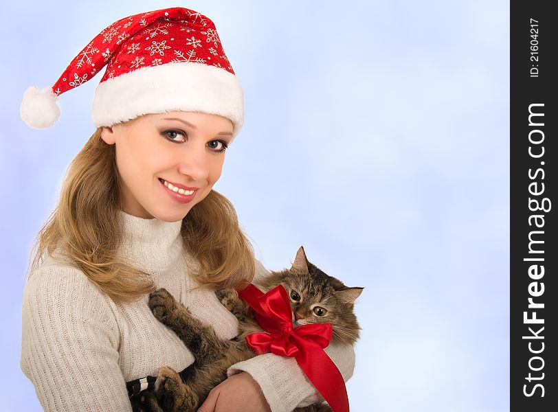 Attractive girl with a cat on a blue background