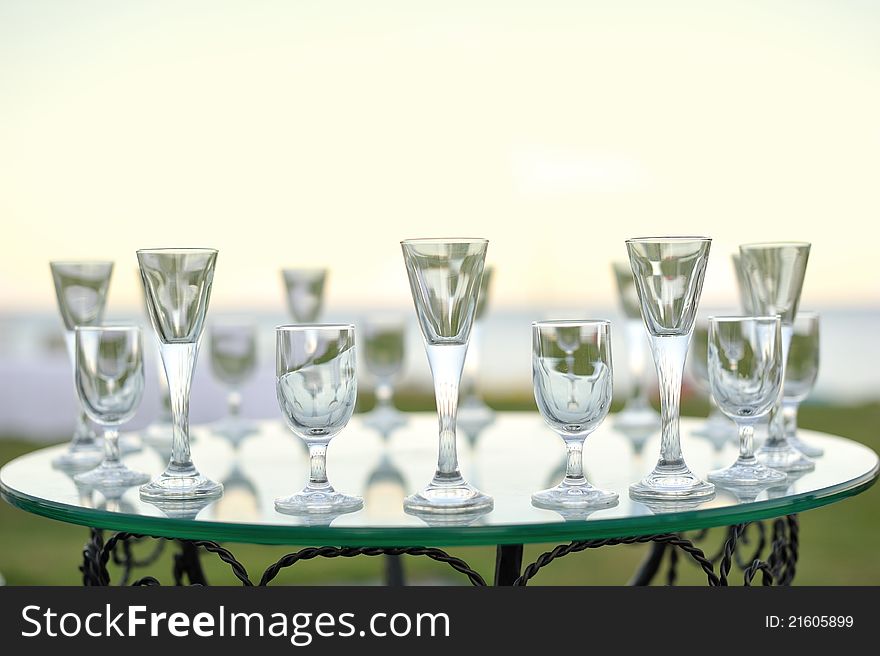 Laying of glasses on a glass table of the different sizes