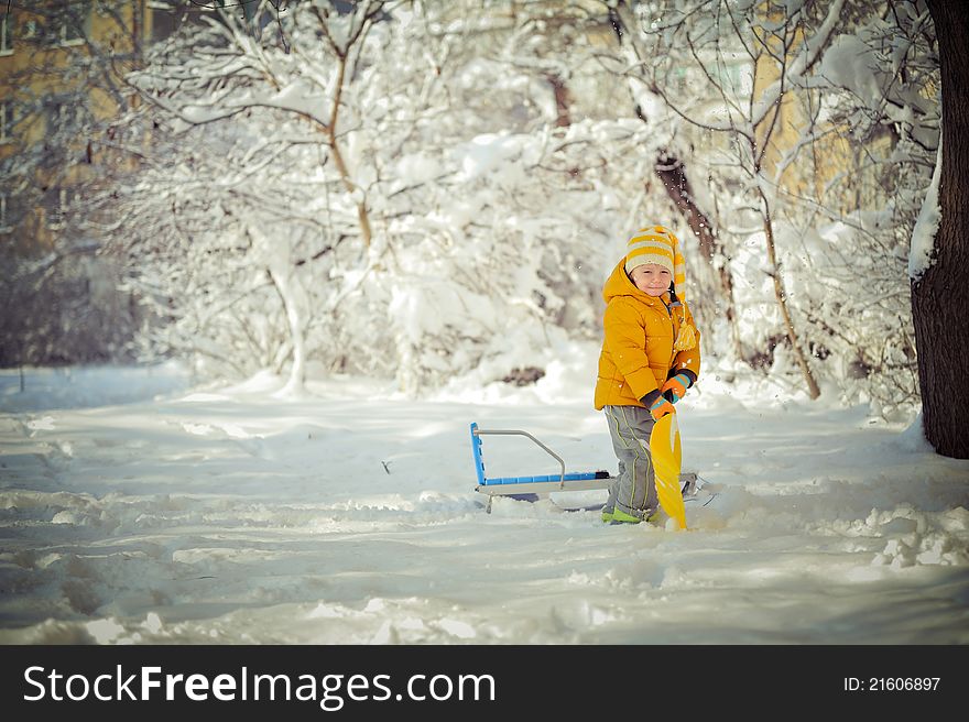 Winter walk of the child and game on snow among trees. Winter walk of the child and game on snow among trees
