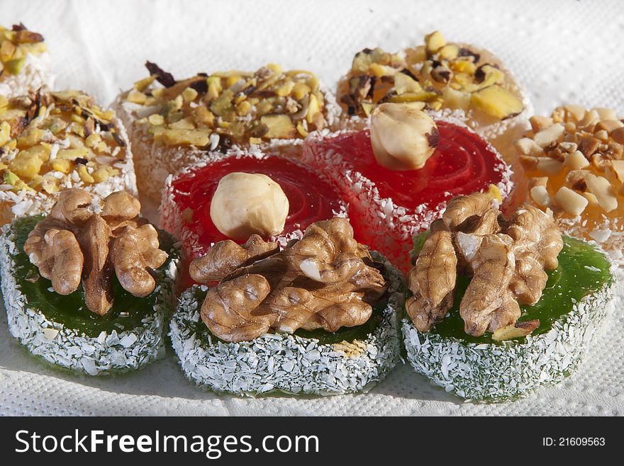 East sweets with a walnut, almonds, are green also red fruit candy