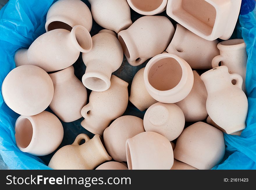 Empty jugs and pots at the blue background