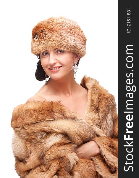 Portrait of mature woman in fur isolated on white. attractive and seductive look, earrings