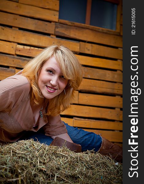 Pretty cowboy girl in farm interior. Pretty cowboy girl in farm interior