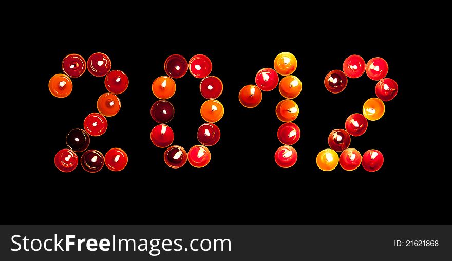 2012 made â€‹â€‹of colored candles on a black background