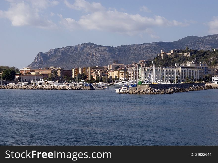 Terracina's port, boats and background mountains.