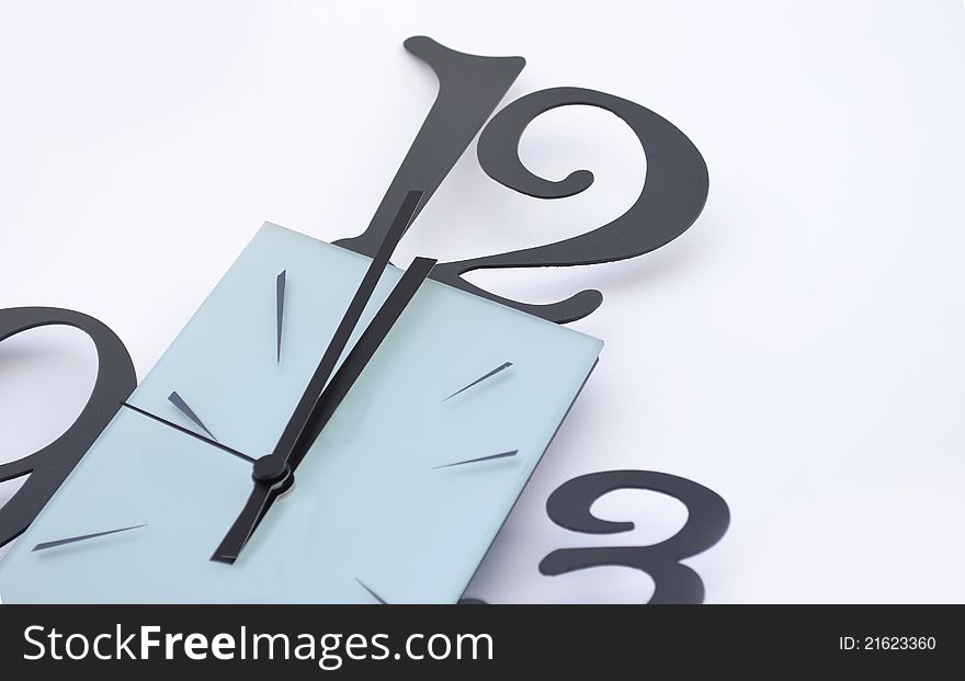 Closeup of a wall clock on white background, one minute to midnight