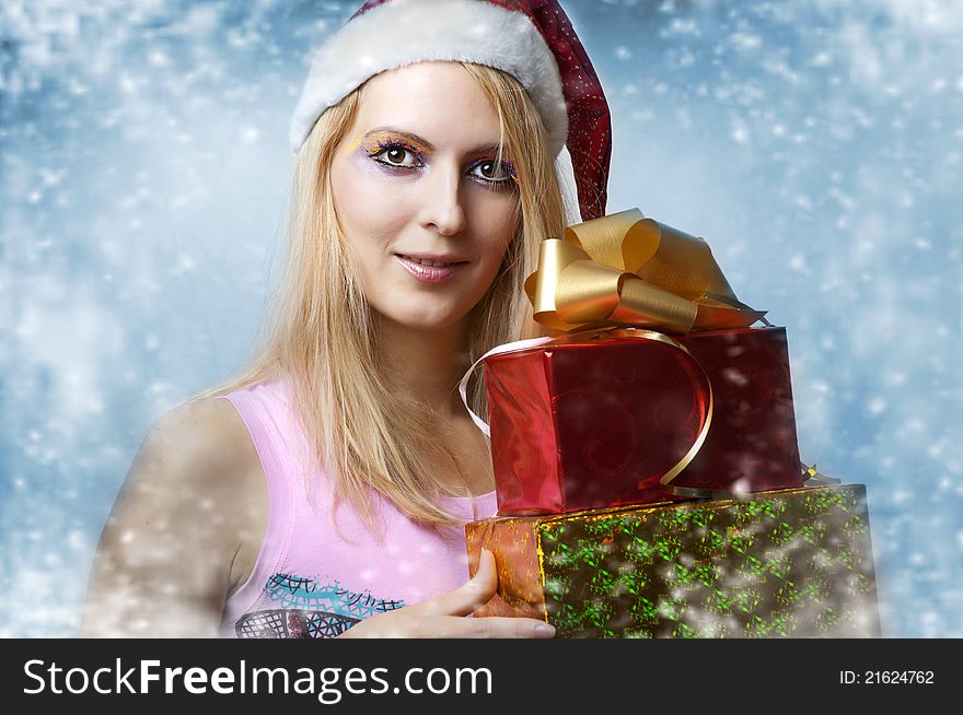 Christmas concept. Beauty portrait happy woman model holding two gift  boxes in hands and smile  in santa claus hat. Christmas concept. Beauty portrait happy woman model holding two gift  boxes in hands and smile  in santa claus hat
