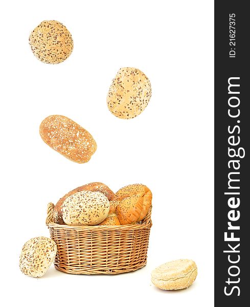 Bread rolls and loaves falling into a basket. Bread rolls and loaves falling into a basket