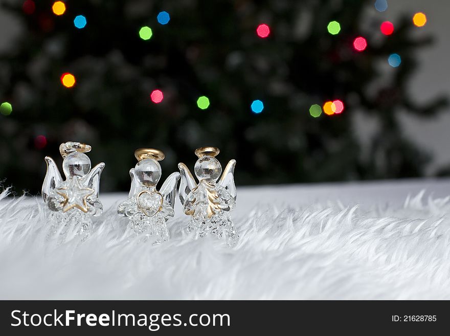 Three Christmas angels decorations on a white fur
