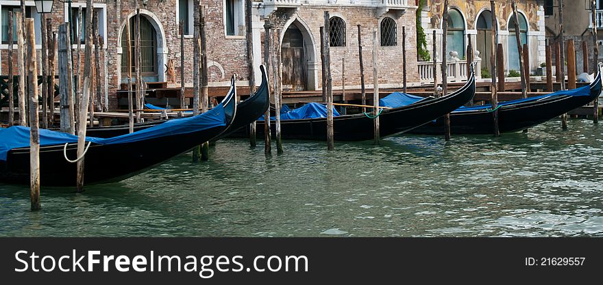 Lined-up Gondola boats moored on one of he canals in Venice. Lined-up Gondola boats moored on one of he canals in Venice.