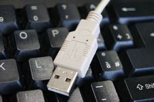 USB Cable On A Keyboard Royalty Free Stock Photos