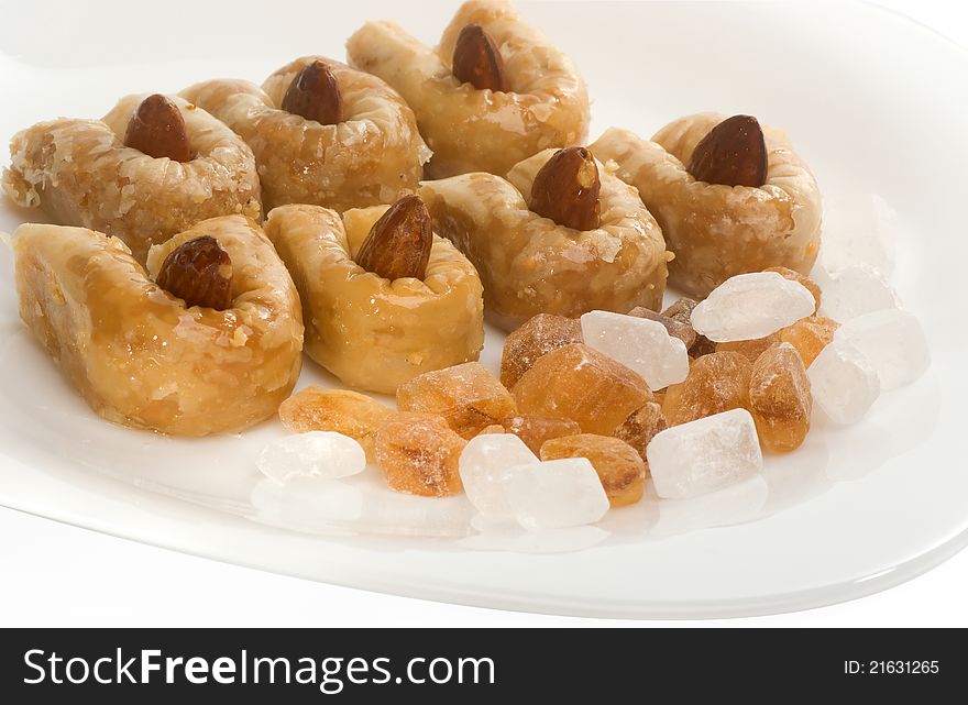 Baklava and sugar in a bowl on a white background