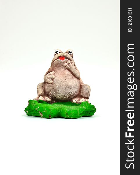 Statuette of a frog on a white background (isolated)