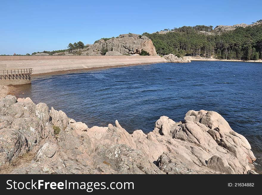 Artificial lake surrounded by a rock dam. Artificial lake surrounded by a rock dam