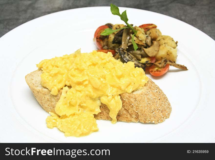 Raw eggs with salt and pepper stirred on top some bread. Raw eggs with salt and pepper stirred on top some bread