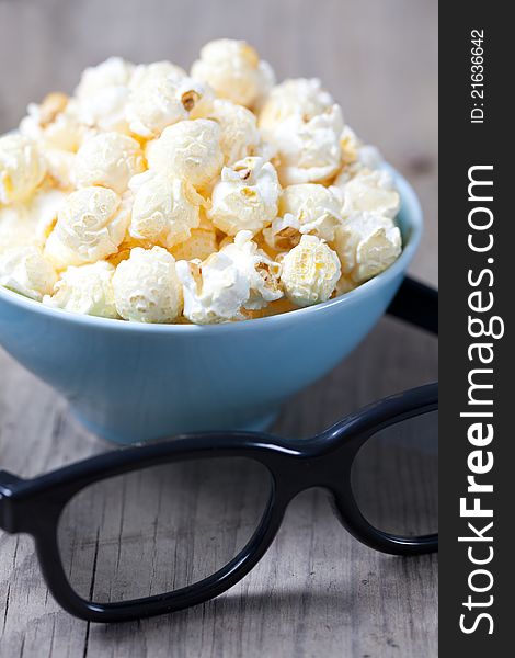 Fresh popcorn in a bowl and 3D glasses. Fresh popcorn in a bowl and 3D glasses