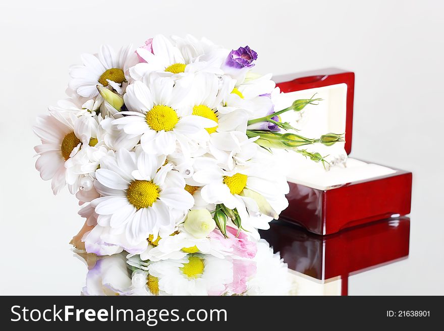Bridal bouquet of daisies and a box with a ring. Bridal bouquet of daisies and a box with a ring