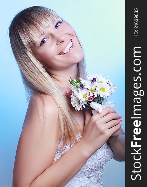 Beautiful young woman with a bouquet of flowers