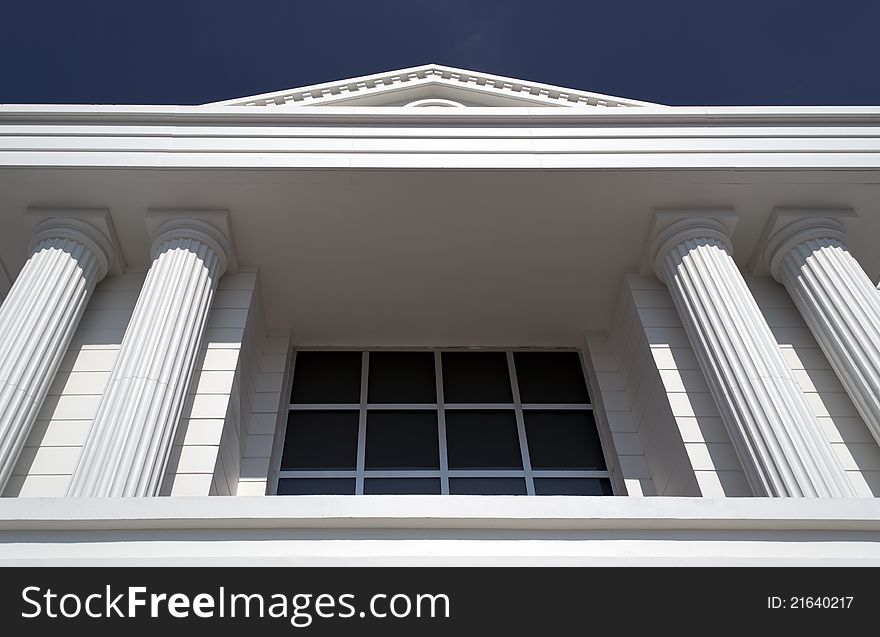 Close-up of classic columns against blue sky. Close-up of classic columns against blue sky