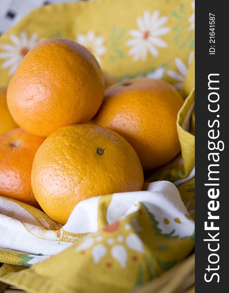 Fresh oranges on floral napkin
