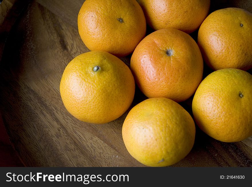 Group of fresh oranges on wood background