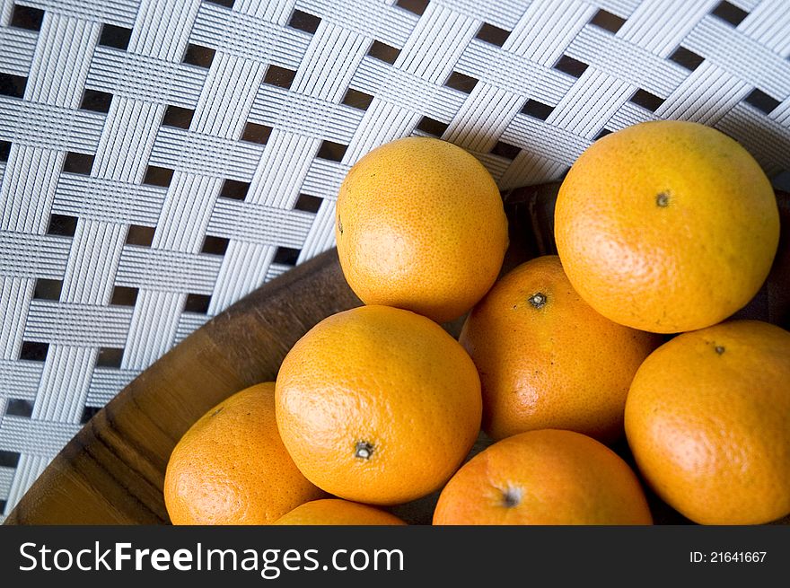 Group of fresh oranges in wooden tray with white background. Group of fresh oranges in wooden tray with white background