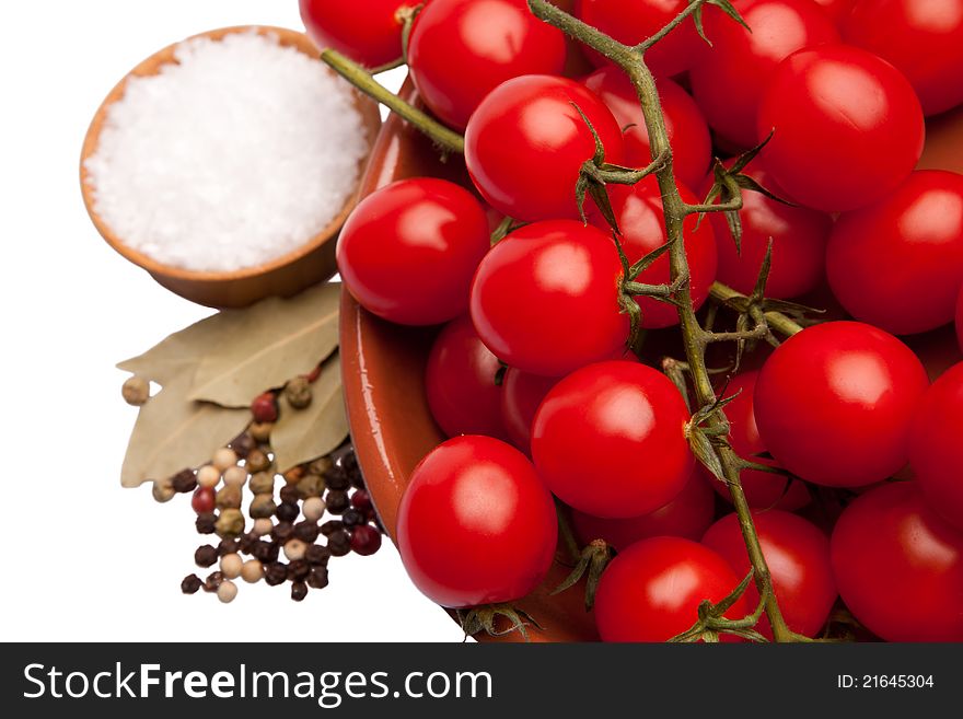 Cherry tomatoes in a bowl with sea salt and pepper on the side