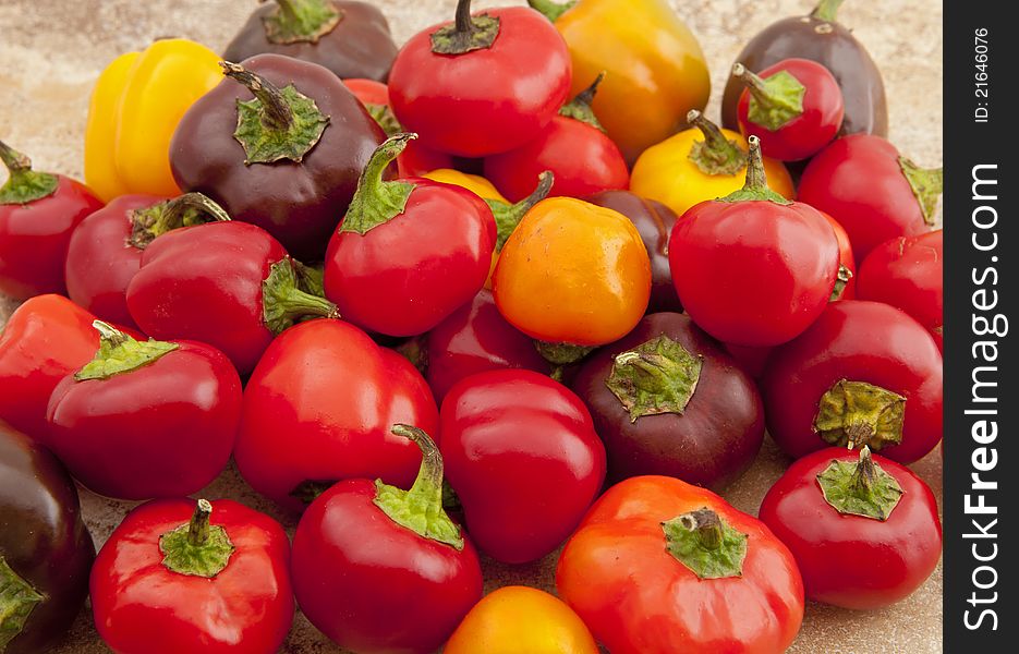 Miniature sweet peppers photographed on kitchen counter surface