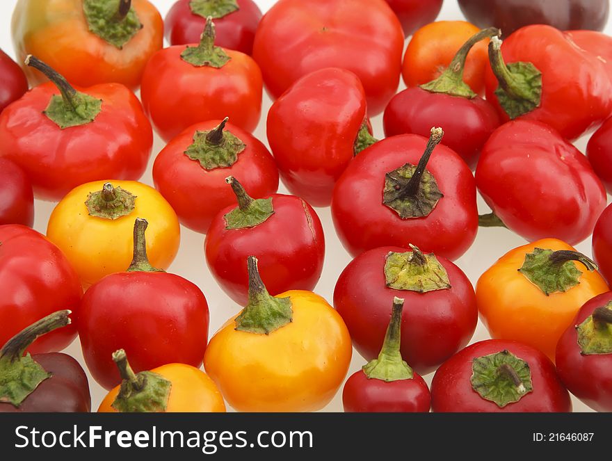 Miniature sweet peppers photographed on a white surface