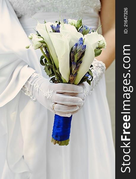 Bride in a white wedding dress holding her pink bouquet. Bride in a white wedding dress holding her pink bouquet