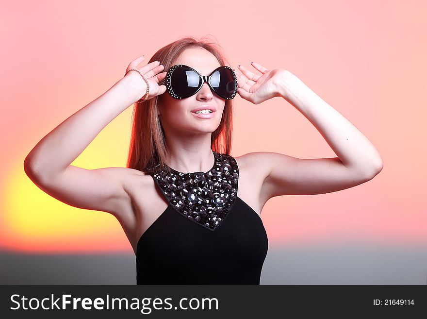 Beautiful young woman in stylish sunglasses on color background. Beautiful young woman in stylish sunglasses on color background