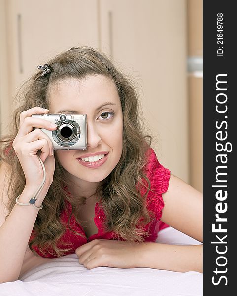 Young girl holding and looking into a camera. Young girl holding and looking into a camera