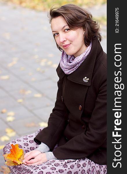 Lovely woman with autumn leaves, seasonal background