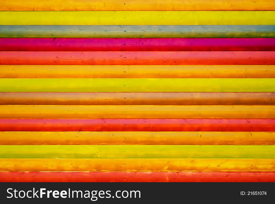 A creative multicolored wooden wall as a background. A creative multicolored wooden wall as a background