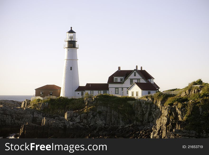 The Portland Head Light lighthouse in Cape Elizabeth, Maine on a clear early morning.