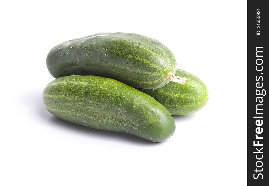 Three green cucumber  on white