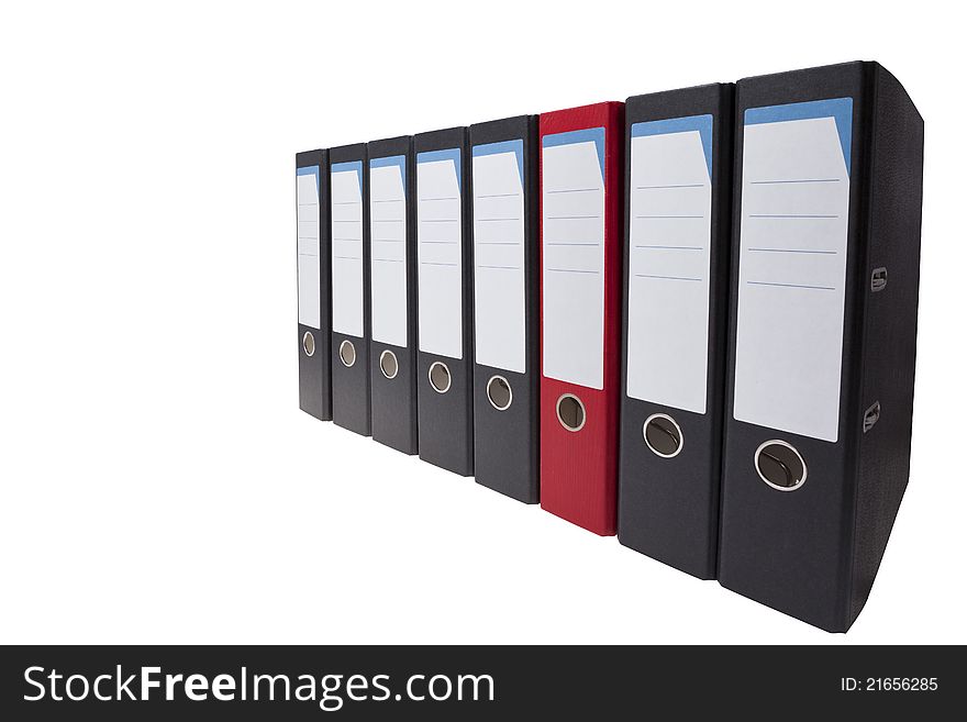 A row of black ringbinders with one different ringbinder. A row of black ringbinders with one different ringbinder