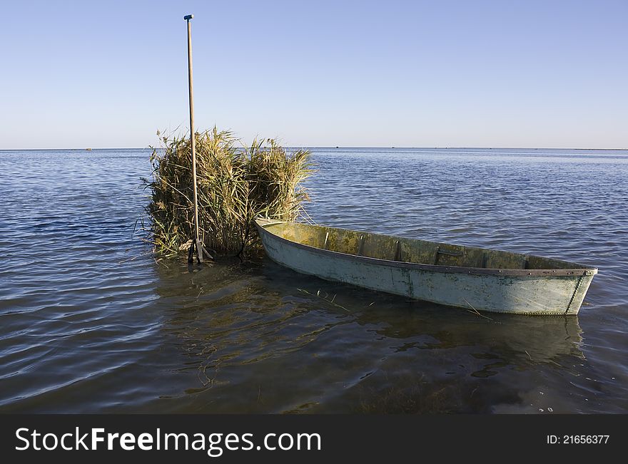 Old hunter boat on summer lake bank. Old hunter boat on summer lake bank