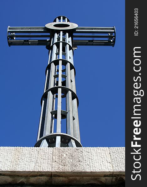 A massive metal cross on a sunny day