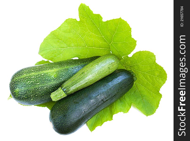 Marrows with green leaves on a white background