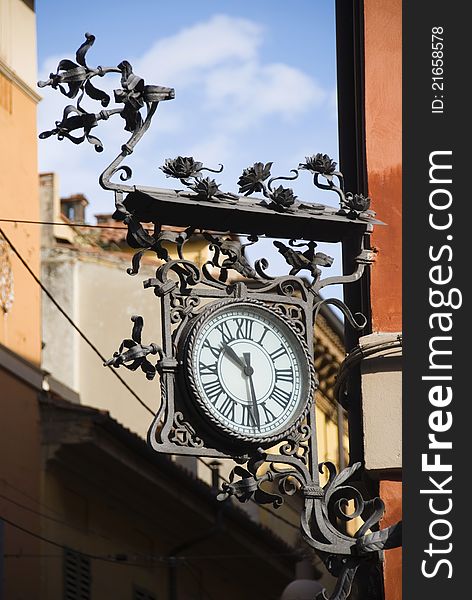 Artistic clock on a building in Bologna, Italy