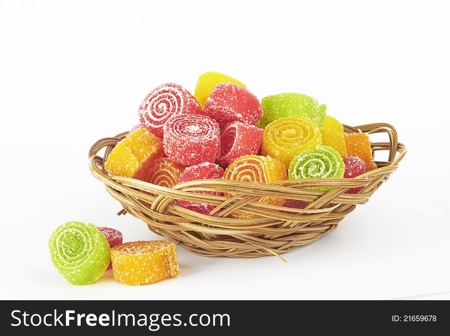 Colorful candy in bowl on white background.