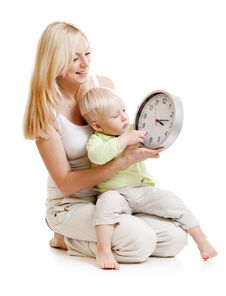 Mother Displaying Time To Her Son Stock Image