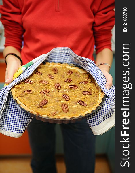 Cook presenting apple and pecan cake. Cook presenting apple and pecan cake