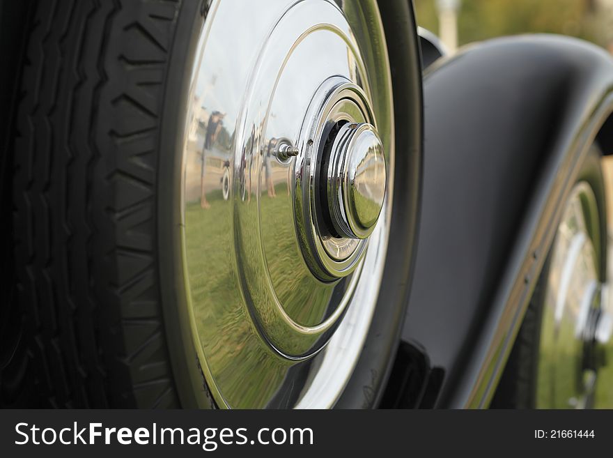 Classic Automobile Wheels with a reflection of a person taking a picture