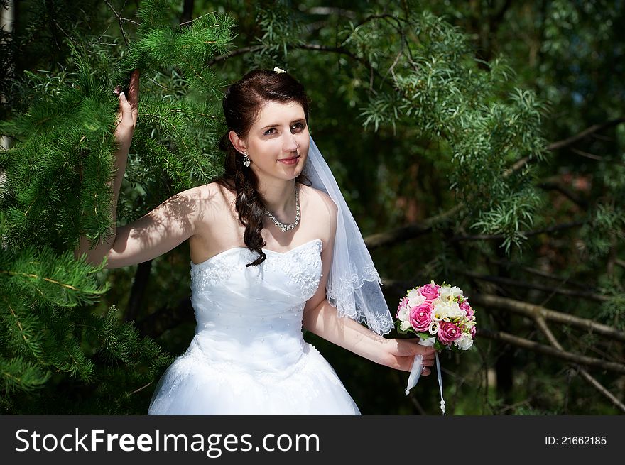 Happy bride with bouquet in wedding walk