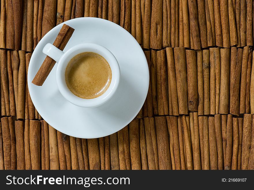 Cup of espresso on cinnamon background. Cup of espresso on cinnamon background