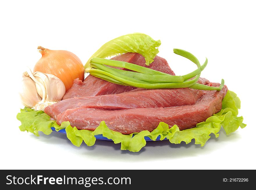 Fresh raw meat with some spice on a plate , on white a white background. Fresh raw meat with some spice on a plate , on white a white background