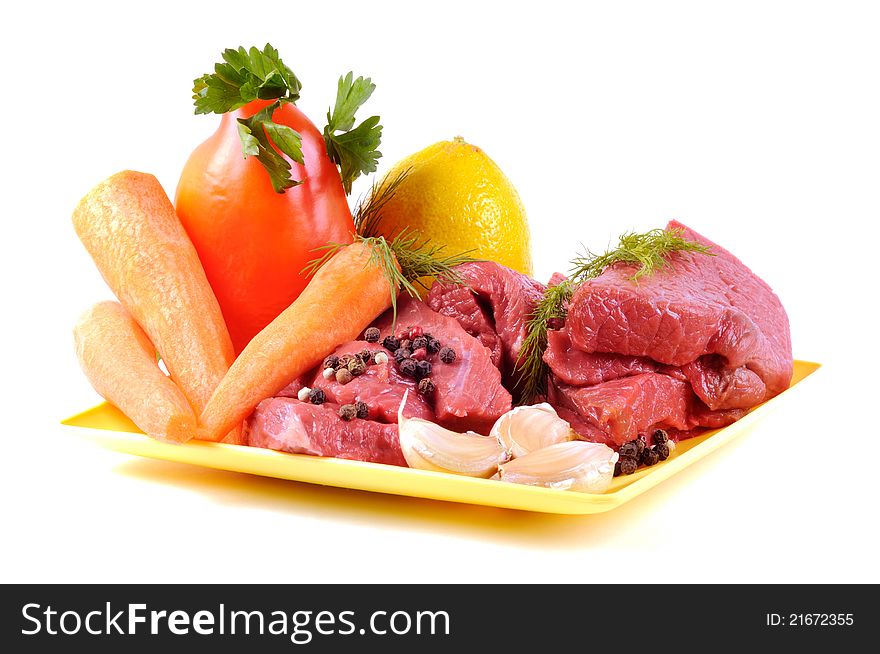 Vegetables some spices and raw meat , on a white background. Vegetables some spices and raw meat , on a white background